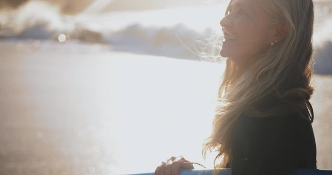Close up senior beautiful woman holding surfboard at the beach