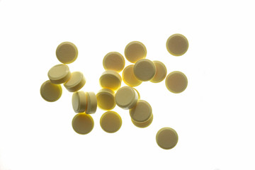 yellow pills on a white background