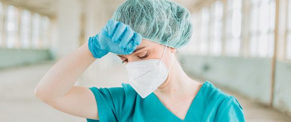 Fototapeta premium Female medical professional feeling tired. Wide format, cinema, panorama, banner