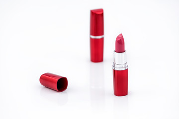 Dark Pink Lipstick on white background. Lipstick for professional make up. Lip care concept. Water...