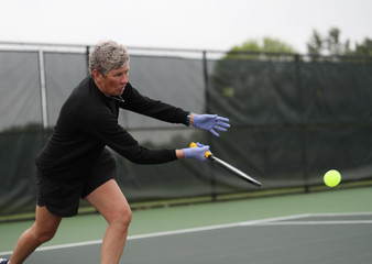 Pickleball is played with rubber gloves due to the Covid-19 pandemic.