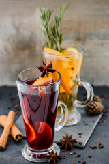 mulled red and white wine wirh spices on dark stone background