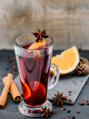 mulled red wine wirh spices on dark stone background