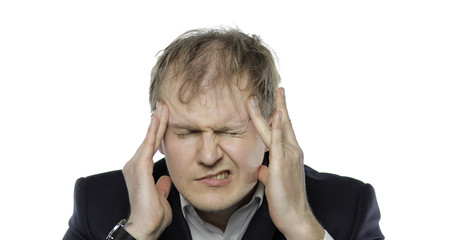 Sleepy young tired businessman. Depressed disheveled worker having headache