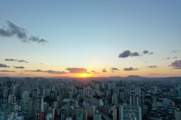 Naklejka na ściany i meble Panoramic aerial view of sunset in the city. Great city life scene.