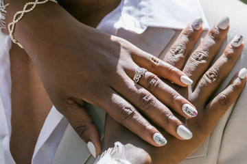 Bride and groom exchanging wedding rings close up during symbolic nautical decor destination...