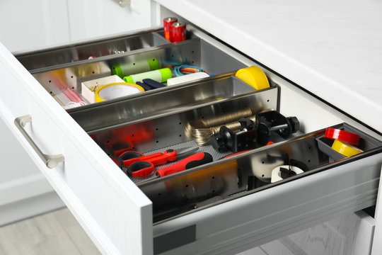 Set of instruments in open desk drawer indoors