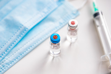 close up on vaccine and medical syringe