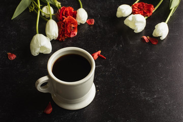 cup of coffee red and white flowers black background