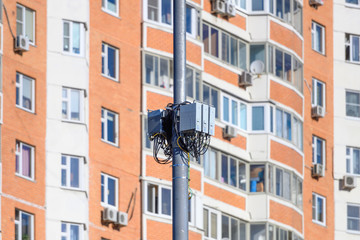 Electronic equipment of a cellular base station against the background of a multi-storey residential building