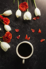 cup of coffee red and white flowers black background
