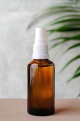 Clear amber glass spray bottle for natural cosmetics or herbal medicine products. Minimal style brand packaging mockup.