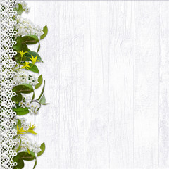 Border of white cherry flowers on a white wooden background