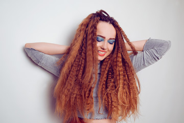 Girl with curled voluminous hair, model with hairstyle in the style of the 80s. 90s, with bright...