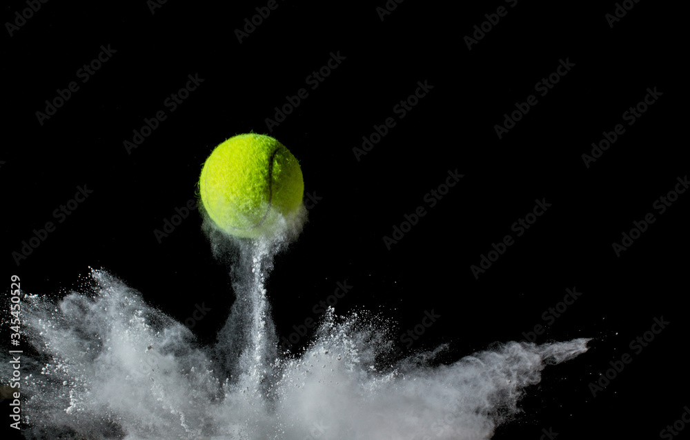 Wall mural tennis ball on black background. concept photo of chalk dust from hitting the line