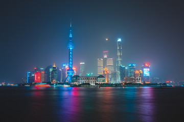 Plakat Scenic Panoramic Cityscape of Shanghai, China during night time with tall and unique skyscrapers making up the skyline 