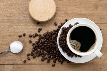 White coffee mugs and coffee beans on an old wooden table. Top View coffee cup on the wooden table background.