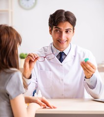 Young woman visiting male doctor ophthalmologist in hospital