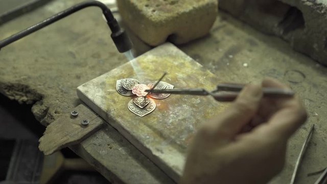 Craftsmen making jewelry From silver ore in the factory