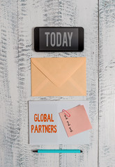 Word writing text Global Partners. Business photo showcasing Two or more firms from different countries work as a team Envelop smartphone notepad note clip marker old wooden vintage background
