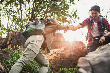 Helping hand outstretched for salvation . Strong hold. Couple hiking help each other in mountains ....
