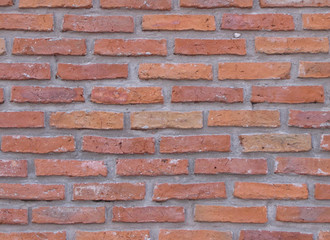 Naklejka premium Orange field brick texture background. Natural brick wall, exposed exposed masonry wall illuminated by sunlight.