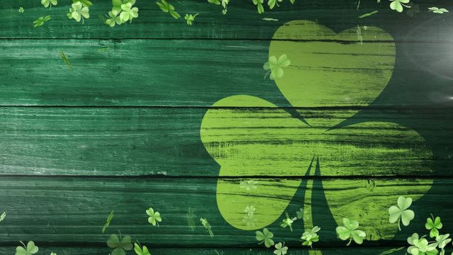 Animation of green clovers floating with clover leaf on background for St. Patricks day
