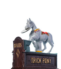 Vintage, all metal, hand painted trick pony coin bank with a turn of the century silver dollar, isolated on white