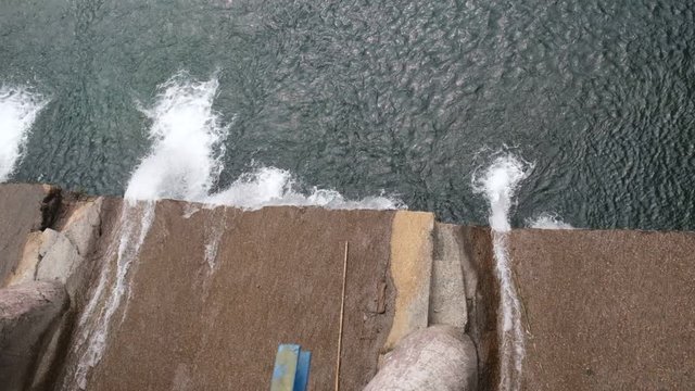 Water is coming out with heavy force from a dam.