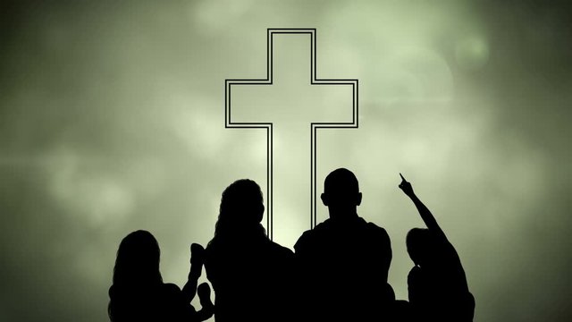 Animation of silhouette of Christian cross and a family over glowing green clouds 