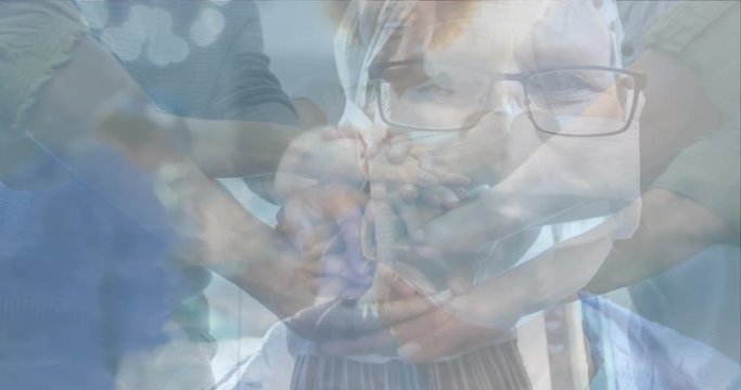 Animation of doctor wearing Coronavirus Covid-19 mask with healthcare workers celebrating 