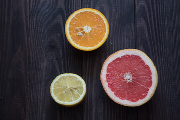 Naklejka na ściany i meble lemon, orange and grapefruit on a wooden background