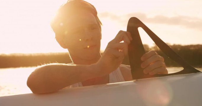 Male rower preparing boat before practice