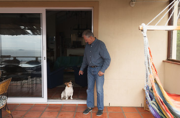 Senior man on his terrace with his dog