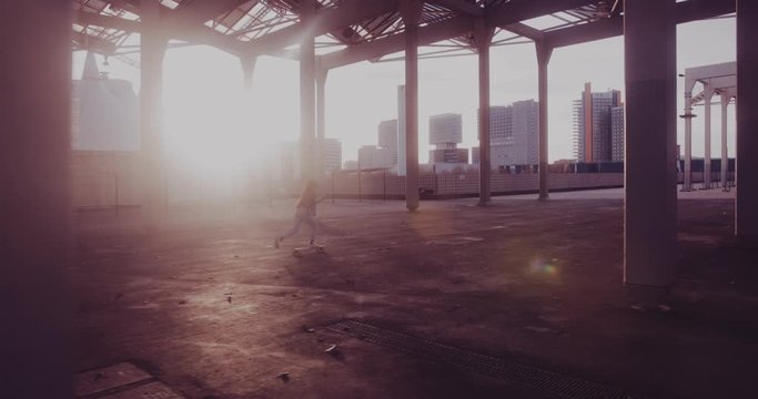 Cool hipster woman skateboarding in urban building