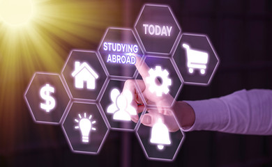 Conceptual hand writing showing Studying Abroad. Concept meaning learn outside of home in foreign...