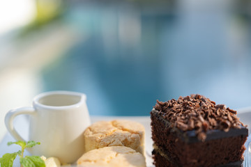 Afternoon tea set with hot tea, chocolate brownie.