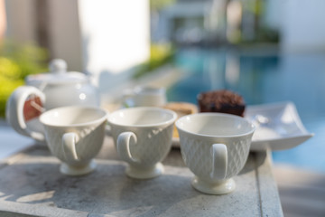 Afternoon tea set with hot tea, chocolate brownie.