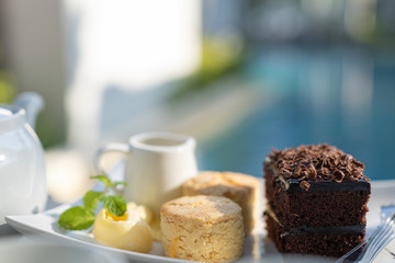 Afternoon tea set with hot tea, chocolate brownie.