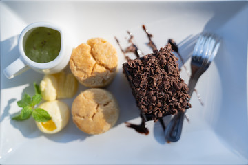 Afternoon tea set with hot tea, chocolate brownie.