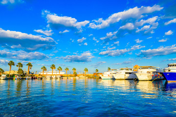 White luxury yachts in a sea harbor of Hurghada, Egypt. Marina with tourist boats on Red Sea - obrazy, fototapety, plakaty