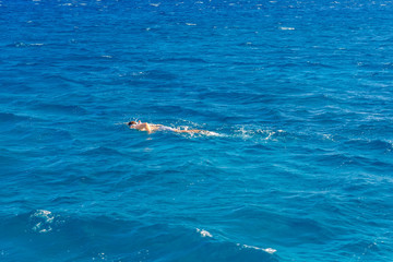 Naklejka premium Tourist snorkeling in a Red sea. Summer vacation concept