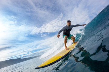 surfer riding on big waves on the Indian Ocean island of Mauritius