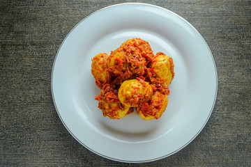 Telur balado (spicy eggs). indonesian food made from eggs, chili, tomatoes, garlic and other and other ingredients