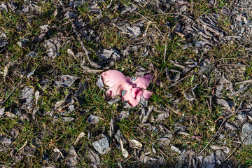Scary broken doll face on a ground