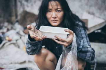 poor people,homeless or beggar begging for help sitting at dirty slum.concept for poverty...