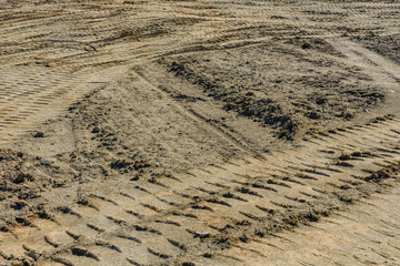 Impints of the truck tires on sand near quarry. Earthworks, offroad