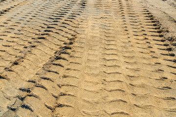 Impints of the truck tires on sand near quarry. Earthworks, offroad