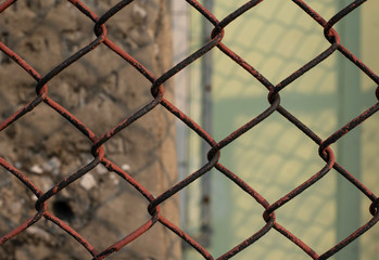 Fototapeta premium old and rusty chain fence put surround in building for secure unauthorized access.
