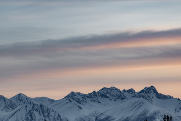 Stunning mountains seen in northern Canada, Yukon Territory at sunset in the winter with snow capped peaks. 